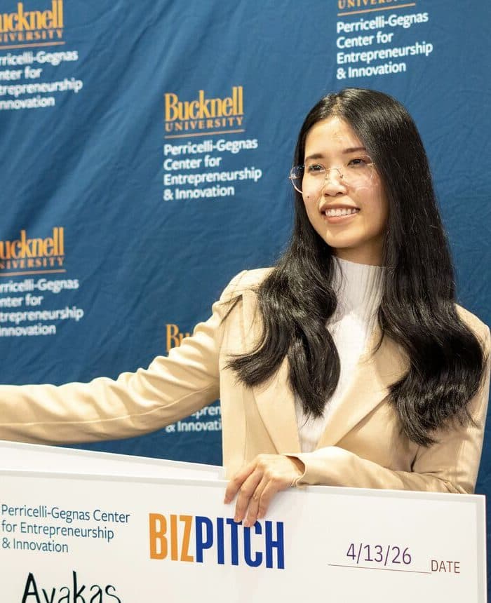 SooAh Lay at Bucknell's BizPitch 2026, holding the Avakas Lab prize cheque.